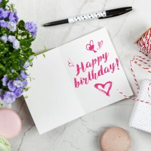 Charming birthday greeting card layout with macarons, flowers, and gift box.